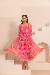 Bright pink mosaic print maxi dress in a stylish setting.