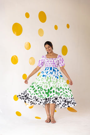 Multicolour smocked maxi dress with vibrant floral patterns and playful ruffles.