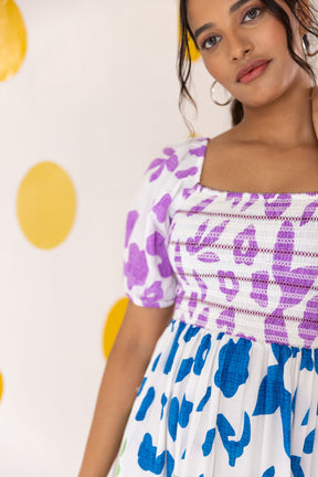 Multicolour smocked maxi dress with vibrant floral patterns.