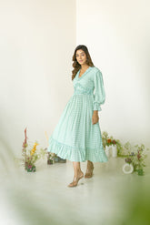 Pastel green ruffle maxi dress with elegant floral details.