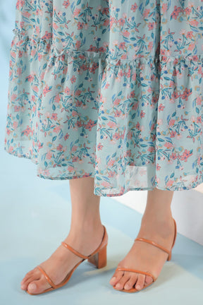 Pastel smocked nursing maxi dress with floral print and stylish sandals.
