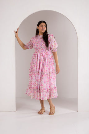 Pastel smocked maxi dress with floral print and puff sleeves.