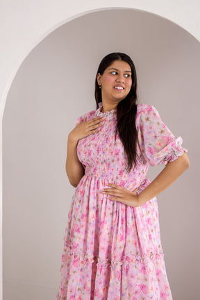 Pastel smocked maxi dress model showcasing floral design and elegant style.