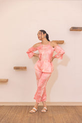 Peach off-shoulder co-ord set model posing stylishly indoors.