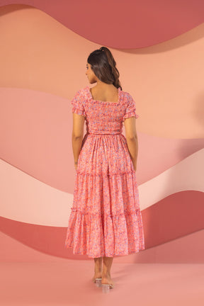 Back view of a floral pink smocked maxi dress.
