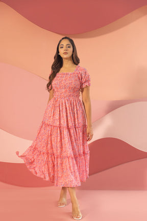 Pink smocked maxi dress, stylish tiered design for summer fashion.
