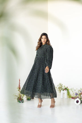 Elegant model wearing PLEATS ON PLEATS MAXI dress in floral design.
