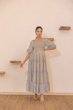Polka smocked maxi dress with puff sleeves and tiered design.