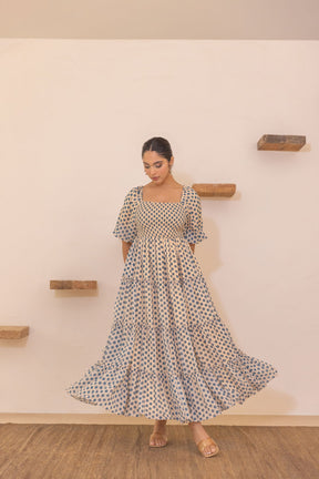 Polka smocked maxi dress with flutter sleeves and layered skirt.