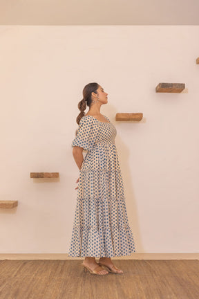 Elegantly modeled polka smocked maxi dress against a minimalist background.
