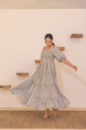 Polka smocked maxi dress in motion, stylish summer fashion.