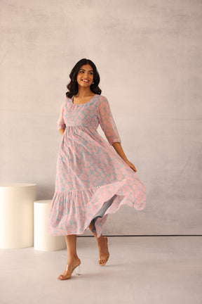 Grey and pink floral maxi dress with elegant design and flowy silhouette.