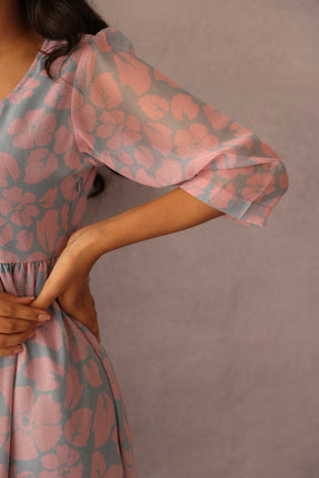 Grey and pink floral maxi dress with sheer sleeves.