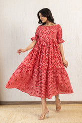 Red off-shoulder cotton maxi dress with floral and chevron patterns.