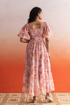 Pastel maxi dress with floral print and puff sleeves.