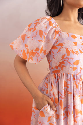 Pastel floral maxi dress with elegant puff sleeves and pockets.