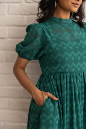 Green Butta Maxi dress with stylish puff sleeves and pockets.