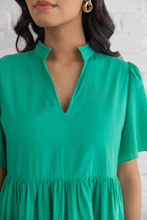 Jade green cotton maxi dress with stylish neckline detail.