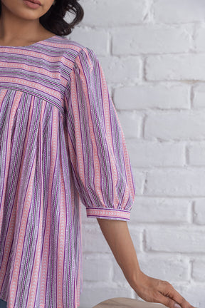 PINK STRIPED COTTON TOP with elegant puff sleeves and playful patterns.