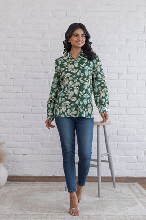 Green cotton shirt top with floral design, model wearing blue jeans.