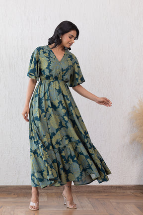 Green floral maxi dress with flutter sleeves and tiered hem.