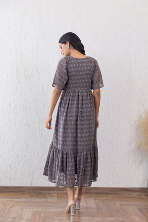 Elegant grey jacquard maxi dress with flared hemline and short sleeves.