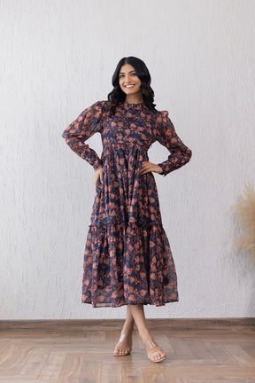 Floral maxi dress with closed neck, model posing confidently.