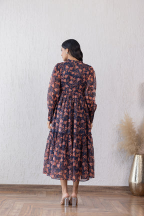 Elegant floral maxi dress with closed neck and tiered design.
