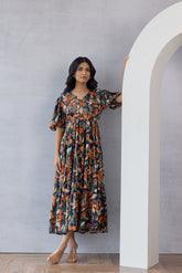 Woman wearing floral MULTI MAXI dress in bright colors.