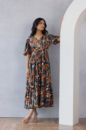 Chic woman wearing floral MULTI MAXI dress against modern backdrop.