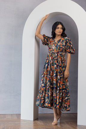 Elegant woman in floral maxi dress, showcasing "MULTI MAXI" fashion.