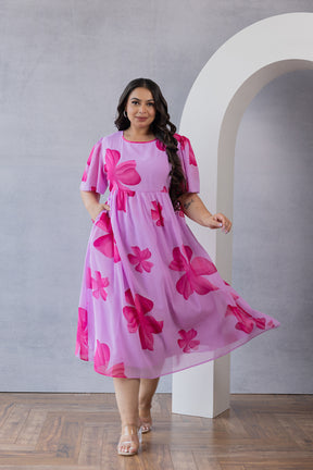 Pink floral maxi dress by Polago Plus for plus-size women.