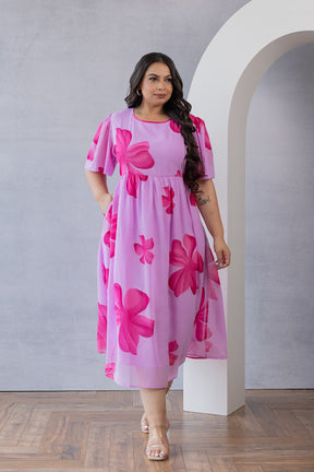 PINK FLORAL MAXI dress on model indoors with soft lighting.