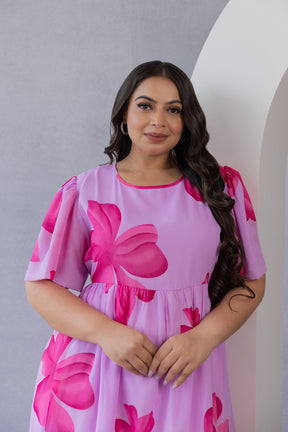 Plus size model wearing PINK FLORAL MAXI dress by POLAGO PLUS.