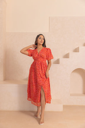 Red chiffon slit maxi dress with floral pattern and stylish silhouette.