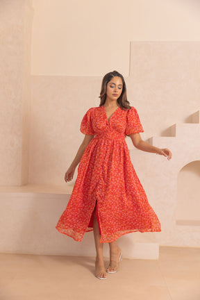 Model wearing a red chiffon slit maxi dress in a styled setting.