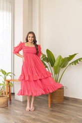 Stylish ruffle smocked nursing maxi dress in vibrant pink.