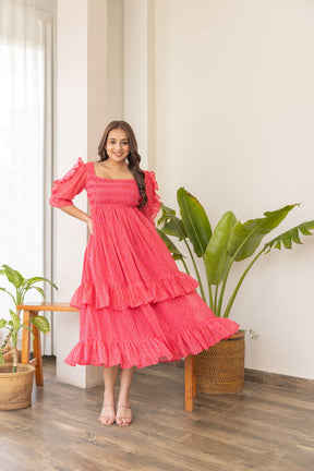 Stylish ruffle smocked nursing maxi dress in vibrant pink.