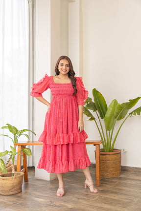 Bright pink ruffle smocked nursing maxi dress for stylish moms.