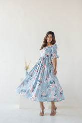 Sky blue floral cotton maxi dress worn by a smiling woman.