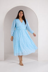 Plus size model in sky blue pleated maxi dress, stylish and elegant.