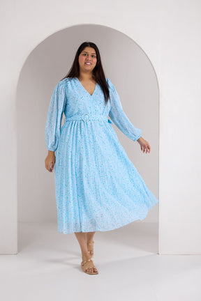 Plus size model in sky blue pleated maxi dress, stylish and elegant.