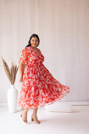 Plus-size woman in vibrant red floral maxi dress, Polago Plus.