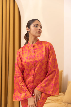 Models the vibrant Tropical Satin Co-Ord outfit in bold pink hues.