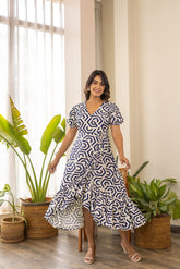 Stylish woman in a geometric patterned wrap nursing maxi dress.