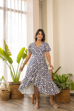 Stylish woman in a geometric patterned wrap nursing maxi dress.