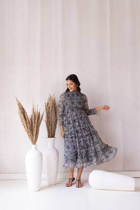 Model showcasing ZEBRA MAXI dress with chic black and white pattern.