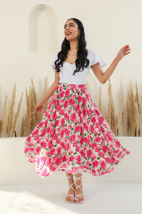 Floral pleated co-ord outfit featuring a smiling woman in a stylish, vibrant setting.