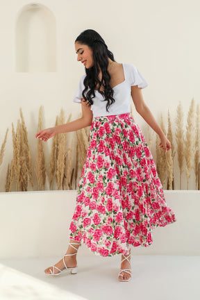Floral pleated co-ord outfit with stylish model against neutral backdrop.