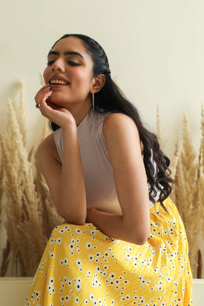 Model wearing trendy floral co-ord set with yellow skirt.